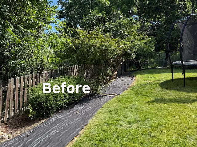 Fence-line planting bed covered in exposed landscape fabric before work