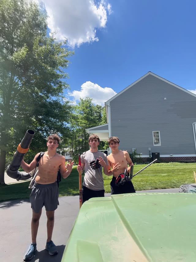 Jacobs Landscaping crew with blowers, rakes and trimmers on a job site